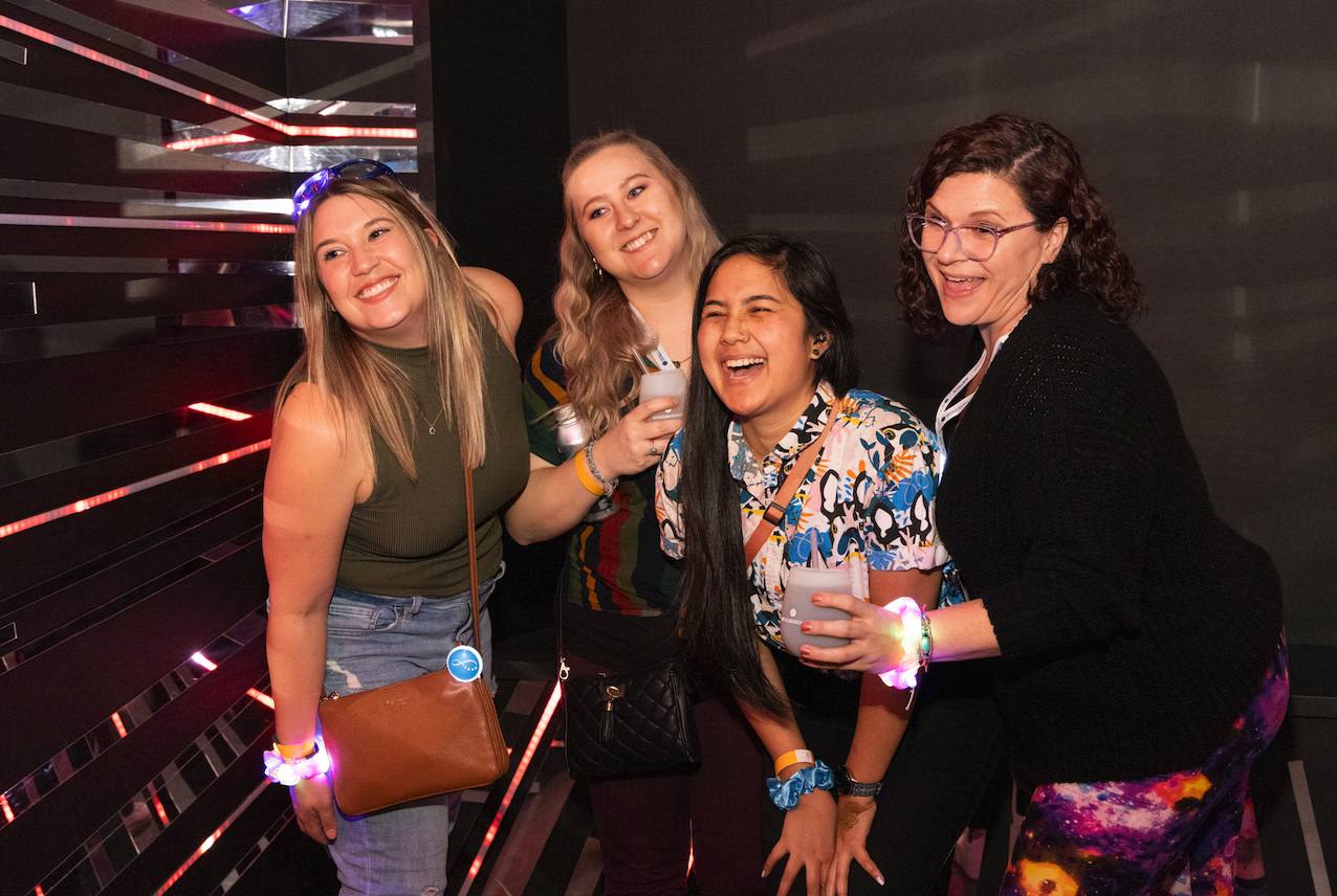 Four women smiling and posing at a photobooth at Vet Tech Reception 2024